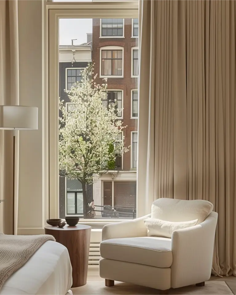 Grommet curtains made of white velvet are installed on rods for living room.