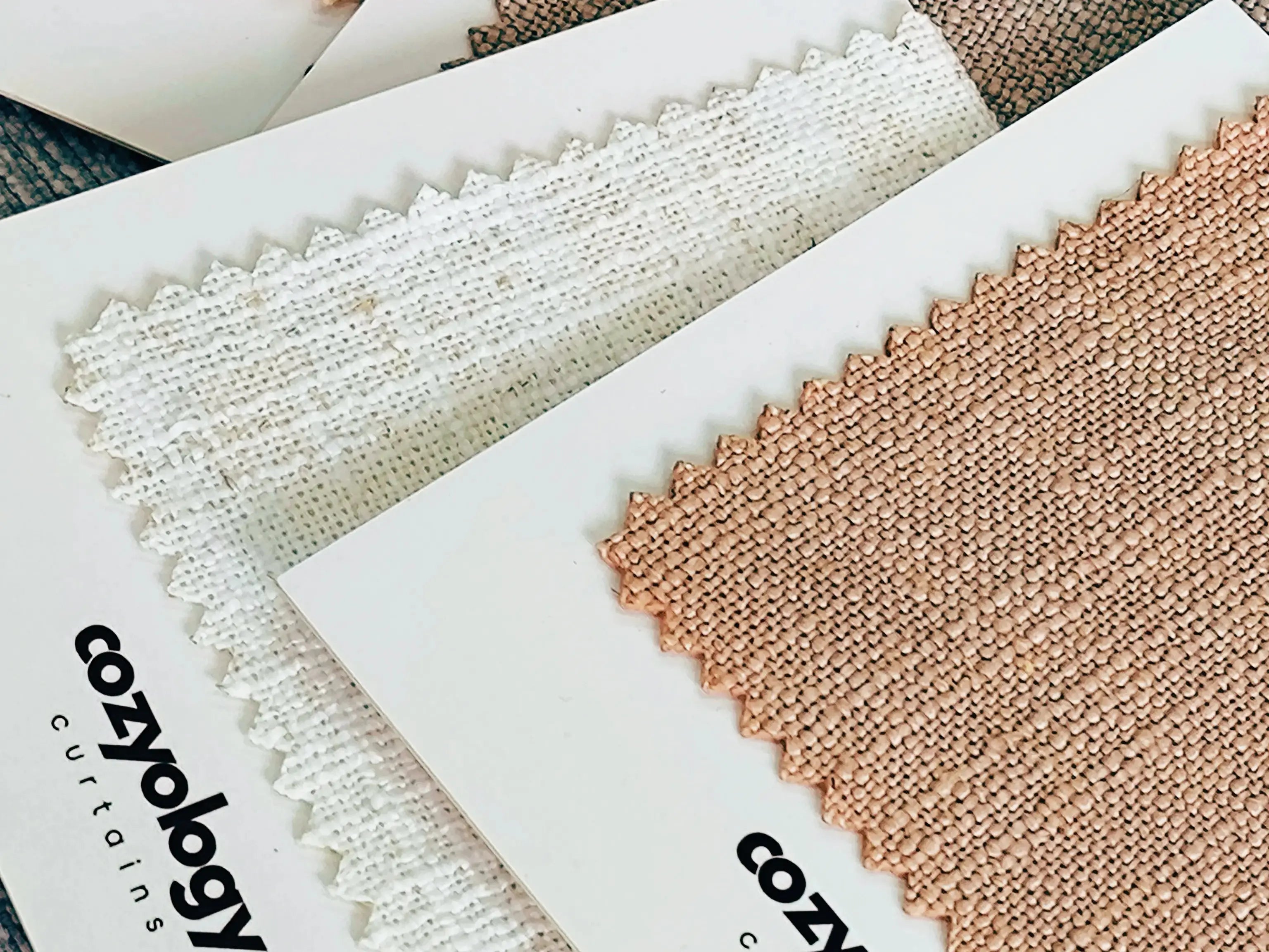 "Fabric sample collection from Cozyology curtains showcasing neutral tones, blending sophistication and coziness