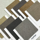 Fabric samples in earthy color tones from Cozyology, offering a variety of neutral shades for curtains and upholstery.